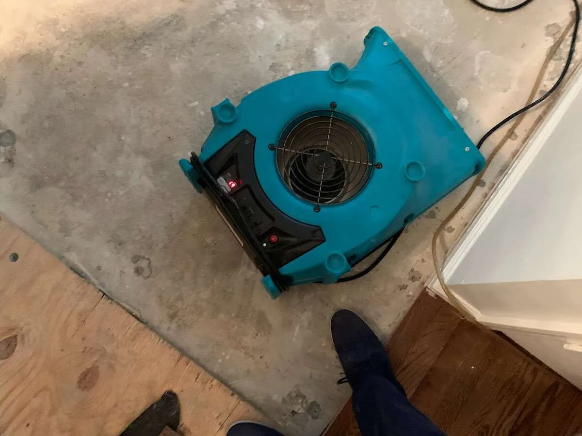 Air mover drying subfloor during Commercial Water Damage Restoration in Frankenmuth